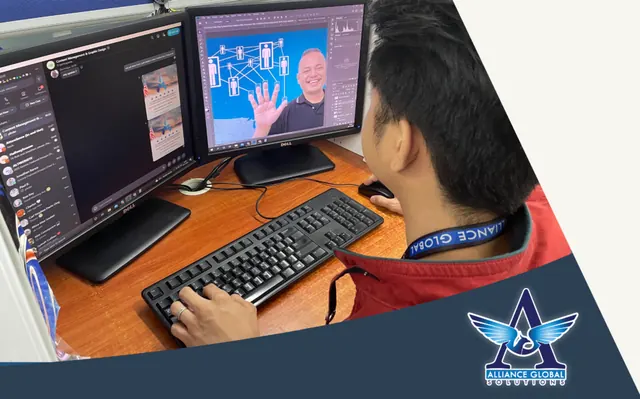 Alliance Global Solutions team member at a dual-monitor desk wearing an AGS lanyard, working in chat and design software