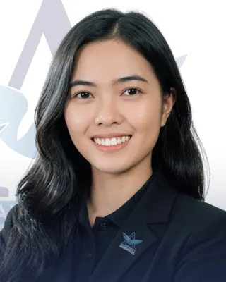 Smiling Alliance Global Solutions team member in a black blazer with a company logo pin