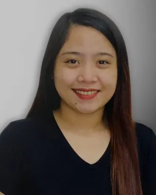 Professional headshot of a smiling Alliance Global Solutions team member with long dark hair in a black V-neck shirt