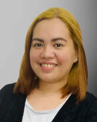 Professional headshot of a smiling Alliance Global Solutions team member in a white shirt and black cardigan